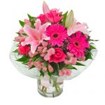 Pink lilies, roses in a clear glass vase