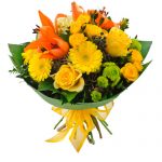 Yellow and orange flowers in a clear vase